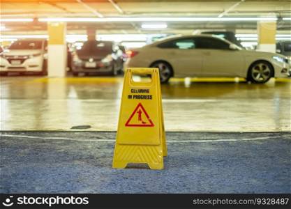 Sign showing warning of caution wet floor in garage building
