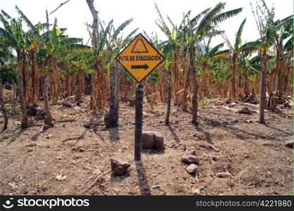 Sign the way of evacuation near fence of banana plantation in Ometepe island, Nicaragua