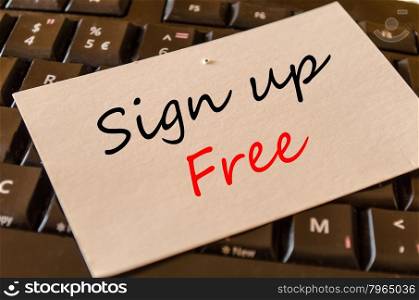 Sign up free text concept note on dark keyboard background