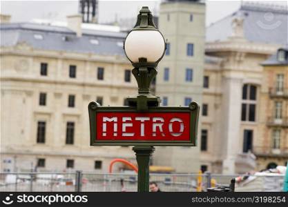 Signboard on a lamppost with buildings in the background, Paris, France