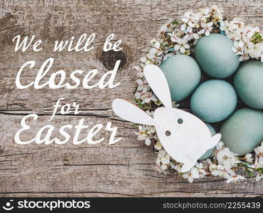 Signboard with the inscription We will be closed for Easter. Easter eggs painted with colorful paints. Closeup, indoors, no people. Congratulations for loved ones, relatives, friends, colleagues. Signboard with the inscription We will be closed for Easter