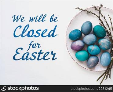 Signboard with the inscription We will be closed for Easter. Easter eggs painted with colorful paints. Closeup, indoors, no people. Congratulations for loved ones, relatives, friends, colleagues. Signboard with the inscription We will be closed for Easter