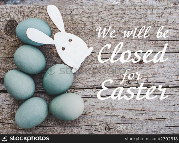 Signboard with the inscription We will be closed for Easter. Easter eggs painted with colorful paints. Closeup, indoors, no people. Congratulations for loved ones, relatives, friends, colleagues. Signboard with the inscription We will be closed for Easter