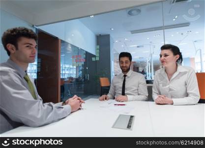 signing contract on partners back, young couple on business meeting with life insurance and bank loan agent at modern office interior