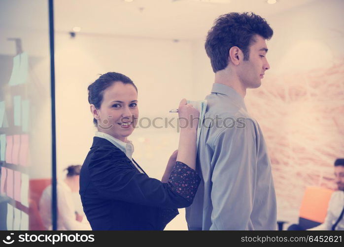 signing contract on partners back, young couple on business meeting with life insurance and bank loan agent at modern office interior