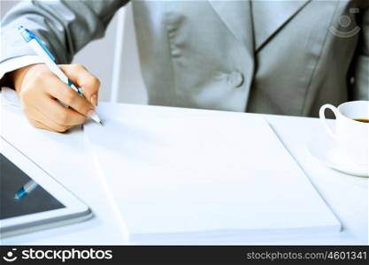 Signing documents. Close up image of businesswoman hands signing documents