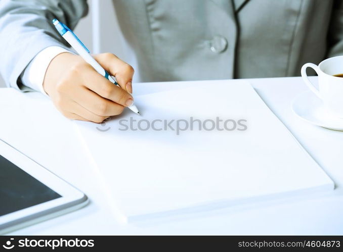 Signing documents. Close up image of businesswoman hands signing documents