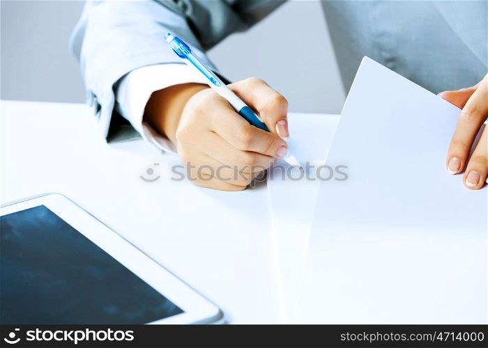 Signing documents. Close up image of businesswoman hands signing documents