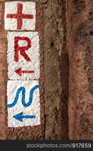 Signpost, hiking sign on house wall