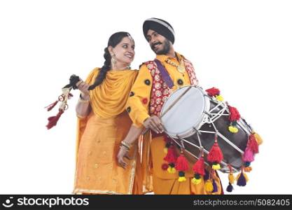 Sikh bhangra dancers standing back to back