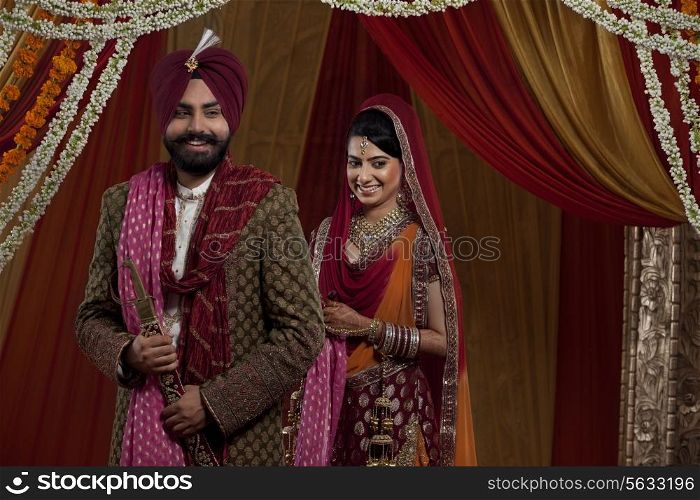Sikh bride and groom standing together