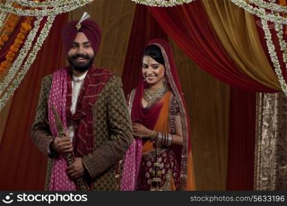 Sikh bride and groom standing together