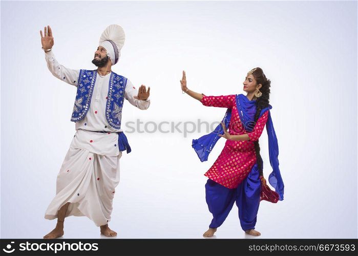 Sikh Couple Doing Bhangra Dance