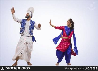 Sikh Couple Doing Bhangra Dance