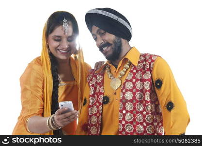 Sikh couple looking at an sms