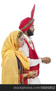 Sikh couple praying
