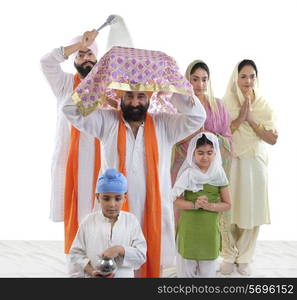 Sikh family performing a ritual ceremony