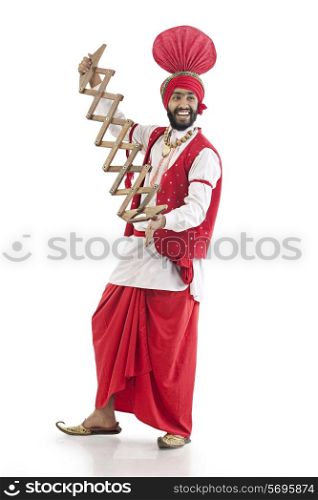 Sikh man holding a supp