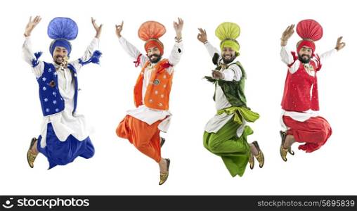 Sikh men jumping in the air