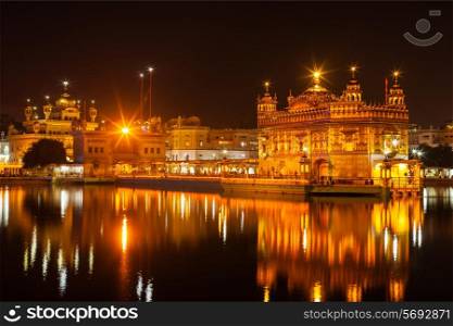 Sikh sacred site gurdwara Sri Harmandir Sahib also known as The Golden Temple also Darbar Sahib illuminated at night. Amritsar, Punjab state, India
