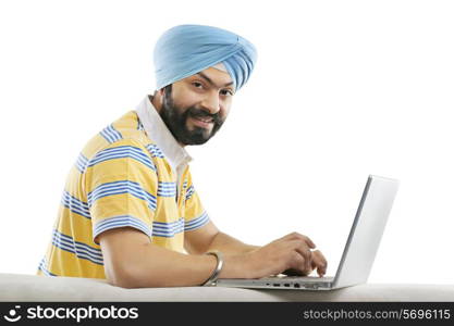 Sikh working on a laptop