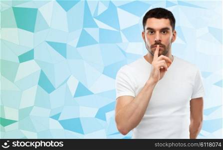 silence, gesture and people concept - young man making hush sign over blue low poly background