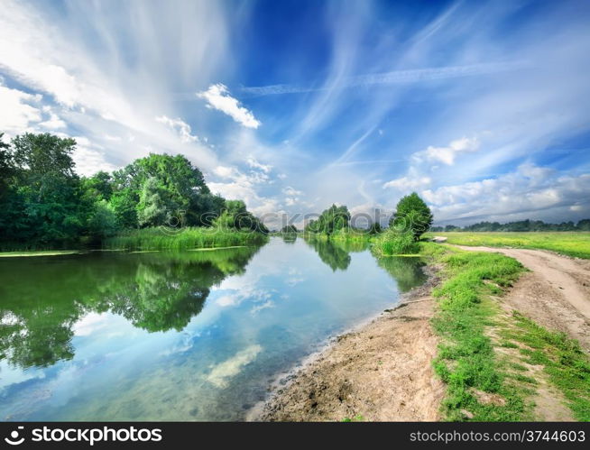 Silent blue river near a country road