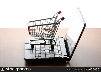 Silhoette of shopping cart and laptop
