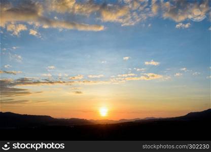 Silhouette beautiful nature landscape of the colorful sky and mountains during the sunrise for background. Silhouette sunrise at mountains