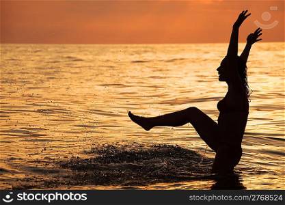 Silhouette beautiful woman play in sea in evening