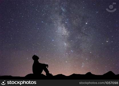 Silhouette business man sitting seeing milky way