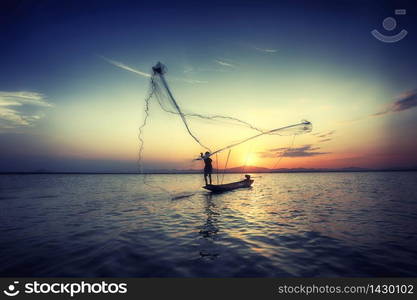 silhouette fisherman and boat in river on during sunset,Thailand