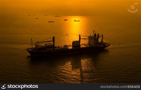 silhouette international shipping cargo containers import and export by the sea the sun golden light background