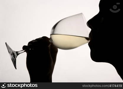 Silhouette man drinking red wine