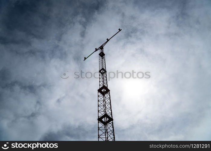 Silhouette of a Airport landing light tower against cloudy sky. Airport security equipment