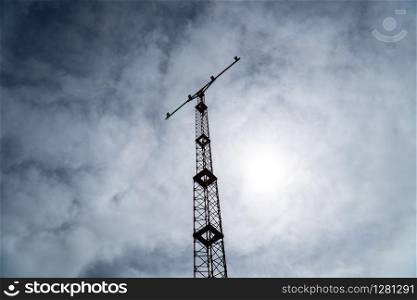 Silhouette of a Airport landing light tower against cloudy sky. Airport security equipment