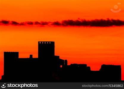 Silhouette of a amazing castle over a red sky