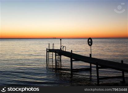 Silhouette of a bath pier by sunset at the Baltic Sea