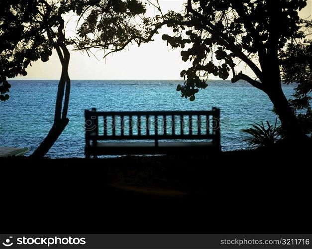Silhouette of a bench near the sea