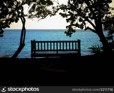 Silhouette of a bench near the sea