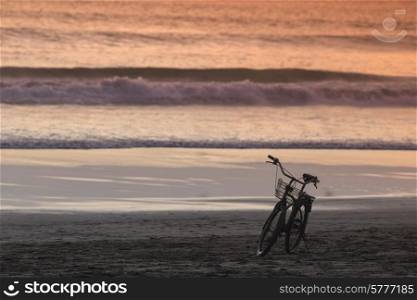 Silhouette of a Bicycle on the Beach at Dusk, Bali, Indonesia