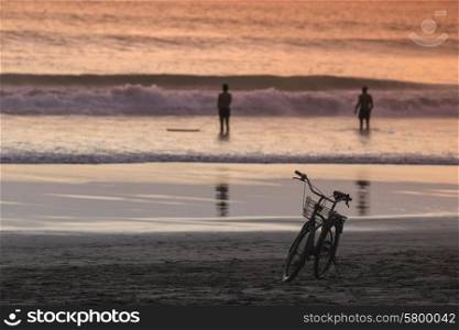 Silhouette of a Bicycle on the Beach at Dusk, Bali, Indonesia