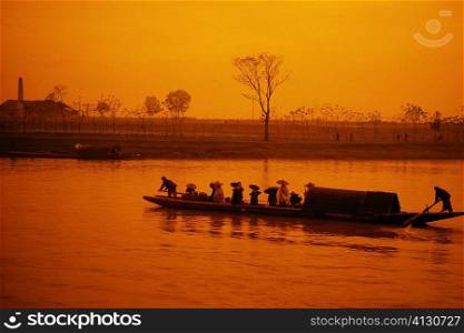 Silhouette of a boat at dusk, Li river, Guilin, China