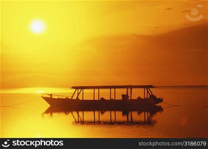 Silhouette of a boat moored in the sea, Bali, Indonesia