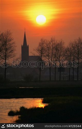 Silhouette of a church at dawn, Schermer, Netherlands