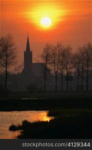 Silhouette of a church at dawn, Schermer, Netherlands