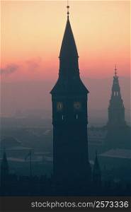 Silhouette of a clock tower at dusk, City Hall, Copenhagen, Denmark