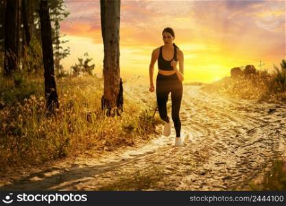 Silhouette of a girl running on a forest road at sunset. Silhouette of girl running on forest road at sunset
