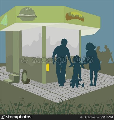Silhouette of a girl sitting on a tricycle with her parents standing beside her