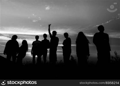 Silhouette of a group of people at sunset,black and white